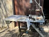 a sewing machine that is sitting outside of a building