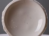 a white bowl sitting on top of a white table