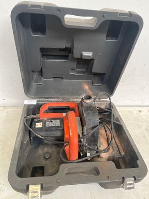 a tool in the case that is open on the floor