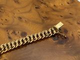 an image of a close up of a wooden table with a chain on it