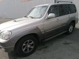 a picture of a silver suv parked in front of a building