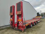 a red flatbed trailer with a large trailer attached to it