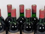 six bottles of wine are lined up in a row on a table