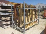 a lot of wood on a metal rack in the yard