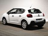 the rear of a white citrole parked in a garage