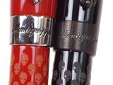 two pens with skulls on them sitting next to each other