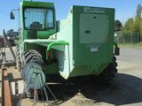 a green tractor that is parked on the side of the road