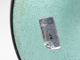 a close up of a glass bowl with a tag on it