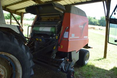 a tractor that is parked under a shelter