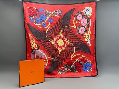 an orange box and a red scarf hanging on a clothes line