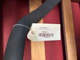 a label on a black tie that is attached to a chair
