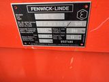 a close up of a red tractor with a black label on it