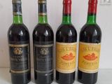 four bottles of wine are lined up on a table