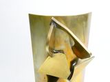 a gold vase with a metal handle on it