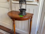 a small table with a birdcage on top of it