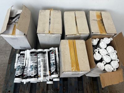 many boxes of cans and cans of paint on a pallet