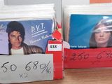 two boxes of cds on a table with a price tag