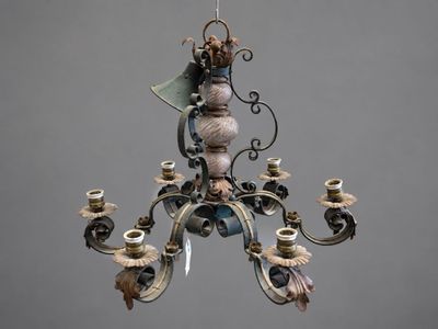 a chandelier with a bird on it hanging from the ceiling