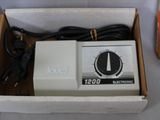 a box with a white electronic device inside of it