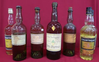 bottles of different types of alcohol lined up on a table