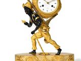 a statue of a man carrying a clock on his back