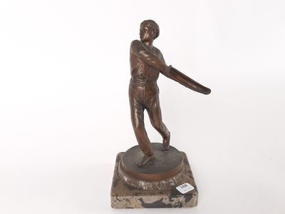 bronze statue of a man holding a baseball bat on a marble base
