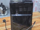 a toaster sitting on top of a wooden table