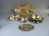 an assortment of silverware including a bowl, saucer, and tray