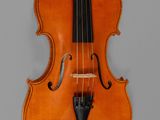 a close up of a violin on a gray background