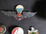 some badges are laying on a black surface with a black background