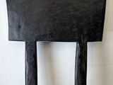 a black chair that is sitting on a hard wood floor