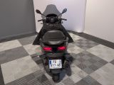 a motorcycle that is parked in a room with a checkered floor