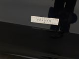 a black car with a sticker on it ' s bumper