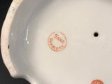 a close up of a white porcelain bowl on a table