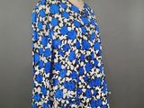 a blue and white floral blouse on a mannequin mannequin