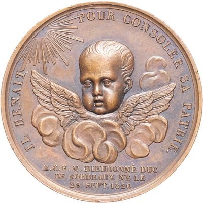 a bronze medal with a little angel on it