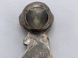 an old silver broochle with a star on it