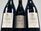 three bottles of wine sitting on top of a table next to each other
