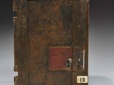 a close up of an old metal safe box with a key on it
