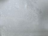 a close up of a bed with a white comforter on it