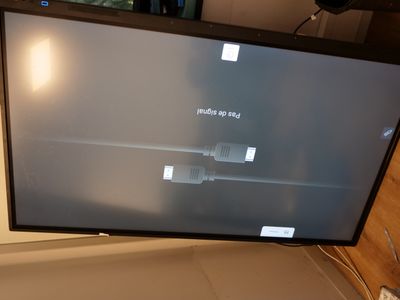 a flat screen tv sitting on top of a table