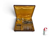 a box with silverware inside of it on a white surface