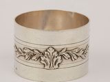 a silver cuff bracelet with a design of leaves and leaves on it