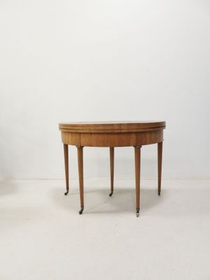 an image of a wooden table with two legs and a round top