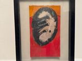 painting in a black frame on a white surface