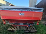 a red trailer that is sitting in the grass