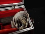 a red suitcase with a stack of money inside of it