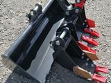 a close up of a skid steer attachment on the ground