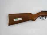a rifle that is on display on a white surface