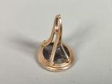 a close up of a gold plated object on a white surface
